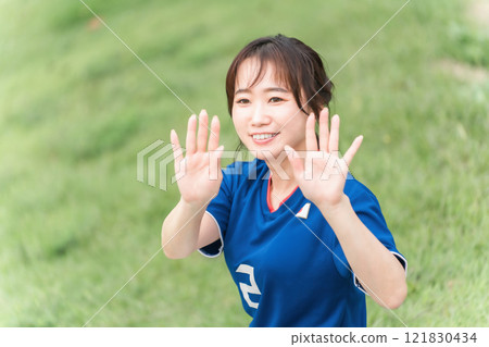 一個微笑的足球迷和支持者在觀看足球比賽時進球並高五 121830434