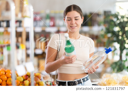 Young woman choosing soda in grocery store Young woman choosing soda in grocery store 121831797