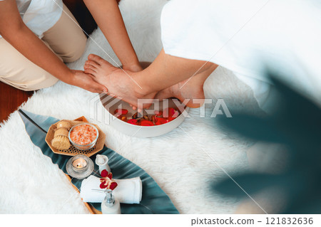 Man indulges in blissful foot massage at luxurious spa salon. Quiescent Man indulges in blissful foot massage at luxurious spa salon. Quiescent 121832636