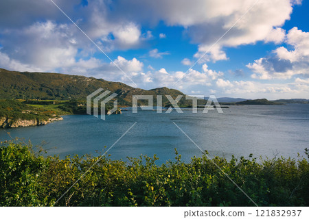 Donegal - A Picturesque Coastal Landscape featuring Calming Waters and Vibrant Lush Greenery all Donegal - A Picturesque Coastal Landscape featuring Calming Waters and Vibrant Lush Greenery all 121832937