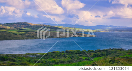 Donegal - A Picturesque Coastal Landscape featuring Calming Waters and Vibrant Lush Greenery all Donegal - A Picturesque Coastal Landscape featuring Calming Waters and Vibrant Lush Greenery all 121833054