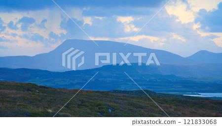 A Beautiful Serene Dusk Illuminates the Rolling Hills and Shimmering Clouds Above A Beautiful Serene Dusk Illuminates the Rolling Hills and Shimmering Clouds Above 121833068