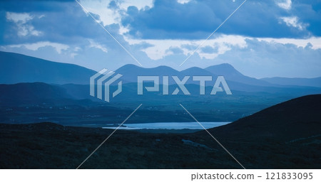 The Misty Mountains are beautifully framed under dramatic and captivating clouds overhead The Misty Mountains are beautifully framed under dramatic and captivating clouds overhead 121833095