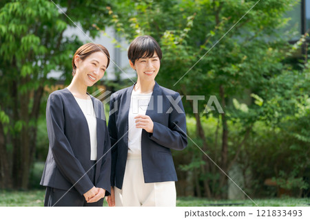 two businesswomen chatting 121833493