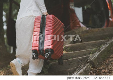 Travelers loading suitcases into a car Travelers loading suitcases into a car 121833645
