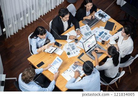 Wide top view diverse analyst team analyzing financial data. Meticulous 121834005