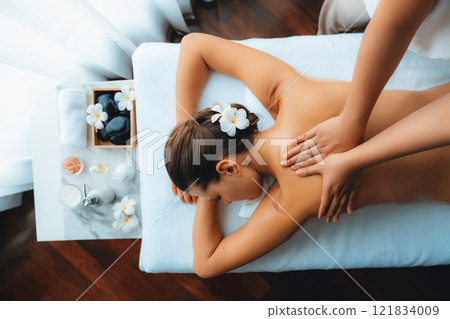 Caucasian woman customer enjoying relaxing anti-stress massage. Quiescent 121834009