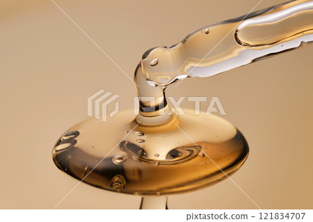 A pipette with a beautiful drop of gel-textured facial serum. 121834707