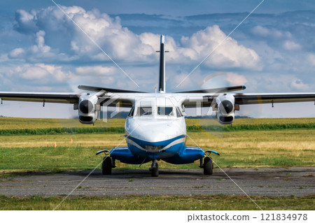 Front view of taxiing a turboprop passenger airplane at a rural airfield Front view of taxiing a turboprop passenger airplane at a rural airfield 121834978