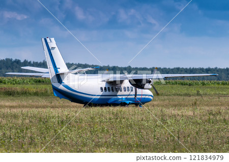 Turboprop passenger airplane at a rural airfield is preparing to take off Turboprop passenger airplane at a rural airfield is preparing to take off 121834979