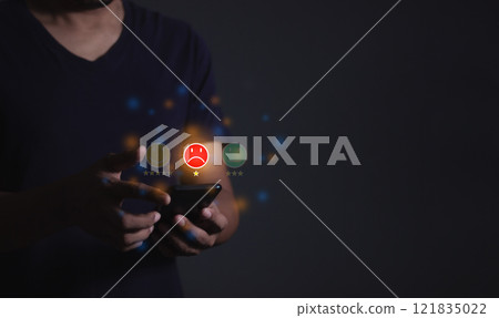 Young man hand holding smartphone to review and gives 1 star 121835022