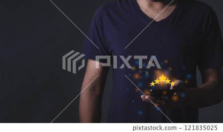 Young Man hand using smartphone with five star to review and give 5 stars  121835025