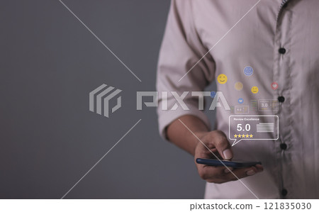 Review Excellence, Young Man hand holding Smart Phone with five star to review and give 5 stars 121835030