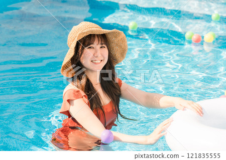 A woman playing in the pool during summer vacation (travel, resort, vacation) 121835555