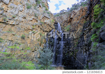 A waterfall cascading down a cliff at Morialta Conservation Park 121836813