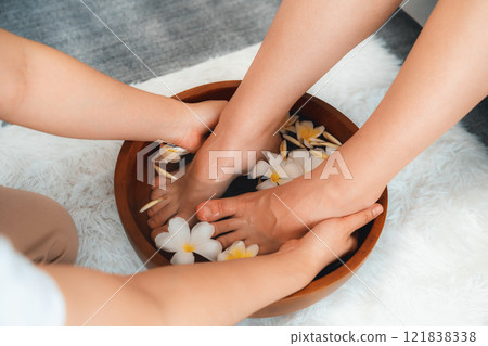 Woman indulges in blissful foot massage at luxurious spa salon. Quiescent 121838338