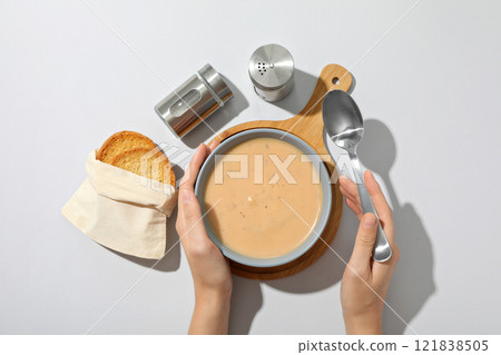 A bowl of cream of mushroom soup with croutons 121838505
