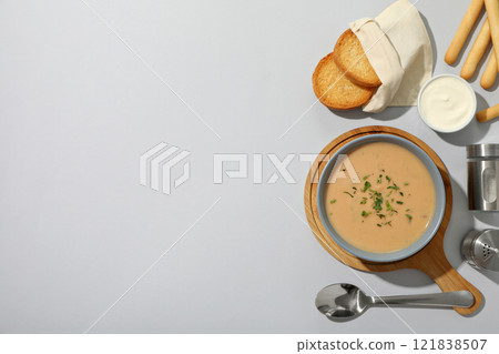 A bowl of cream of mushroom soup with croutons 121838507