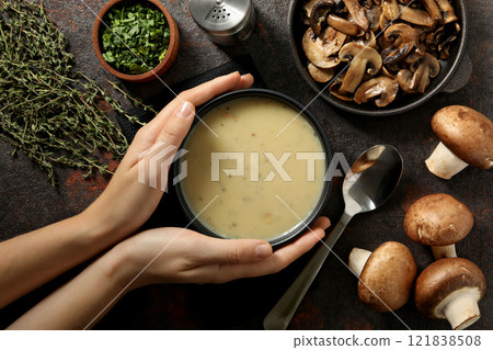 A bowl of mushroom cream soup on a dark background 121838508