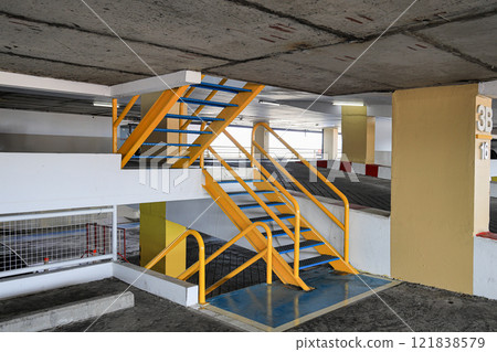 Stairs connecting floors of the parking lot, Old parking garage stairs, Empty metal building stairway composition. 121838579