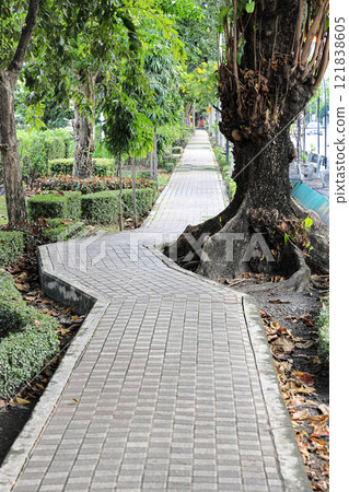Long paved brick footpath, Brick path or sidewalk with perspective going into the distance, abstract background of tiles, footpath, sidewalk in portrait orientation. Long paved brick footpath, Brick path or sidewalk with perspective going into the distance, abstract background of tiles, footpath, sidewalk in portrait orientation. 121838605