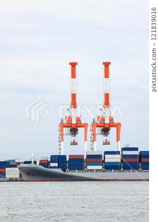 Container port at Osaka Japan, container crane at Industrial port for cargo container ship. Cargo transportation and activity at modern shipping container terminal. 121839016
