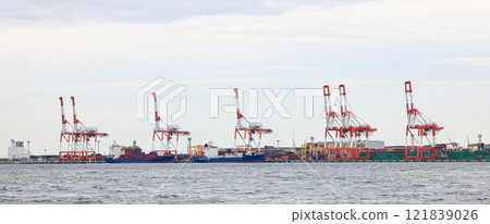 Container port at Osaka Japan, container crane at Industrial port for cargo container ship. Cargo transportation and activity at modern shipping container terminal. 121839026