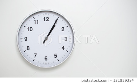 Minimalist White Clock with Silver Frame Striking 13.05/01.05 on White Background. Perfect for Time Management and Corporate Campaigns Minimalist White Clock with Silver Frame Striking 13.05/01.05 on White Background. Perfect for Time Management and Corporate Campaigns 121839354