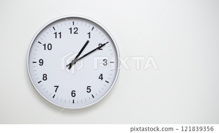 Minimalist White Clock with Silver Frame Striking 13.10/01.10 on White Background. Perfect for Time Management and Corporate Campaigns 121839356