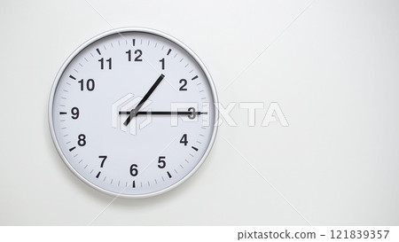Minimalist White Clock with Silver Frame Striking 13.15/01.15 on White Background. Perfect for Time Management and Corporate Campaigns Minimalist White Clock with Silver Frame Striking 13.15/01.15 on White Background. Perfect for Time Management and Corporate Campaigns 121839357