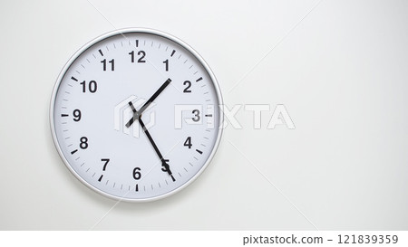 Minimalist White Clock with Silver Frame Striking 13.25/01.25 on White Background. Perfect for Time Management and Corporate Campaigns Minimalist White Clock with Silver Frame Striking 13.25/01.25 on White Background. Perfect for Time Management and Corporate Campaigns 121839359
