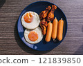 Breakfast set of Fried eggs, sausage and fried chicken wing. 121839850