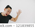 Cheerful man waving hand to say hi in black t-shirt isolate on white. 121839855