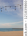 Restaurant light bulb line over beach with blue sky. 121839860