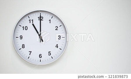 Minimalist White Clock with Silver Frame Striking 11.00/23.00 on White Background. Perfect for Time Management and Corporate Campaigns Minimalist White Clock with Silver Frame Striking 11.00/23.00 on White Background. Perfect for Time Management and Corporate Campaigns 121839873