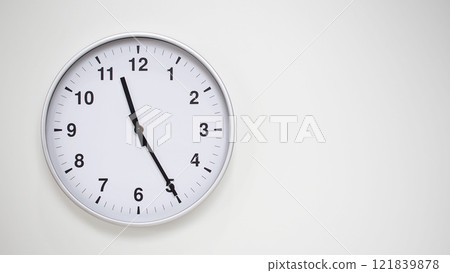 Minimalist White Clock with Silver Frame Striking 23.25/11.25 on White Background. Perfect for Time Management and Corporate Campaigns 121839878