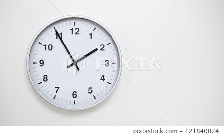 Minimalist White Clock with Silver Frame Striking 13.55/01.55 on White Background. Perfect for Time Management and Corporate Campaigns Minimalist White Clock with Silver Frame Striking 13.55/01.55 on White Background. Perfect for Time Management and Corporate Campaigns 121840024