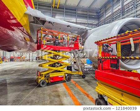 Aircraft Maintenance in Hangar with Scissor Lifts and Engines. High quality photo 121840039