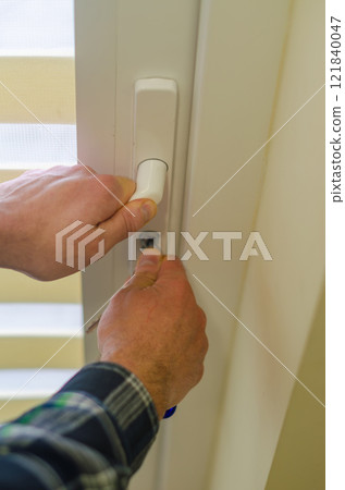male hands unlocking locking the door with keys . High quality photo 121840047