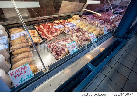 Budapest, Hungary. August 29,2022. The covered market, detail of a meat vendor's stall. The various cuts are displayed with a tag with type and price. 121840074