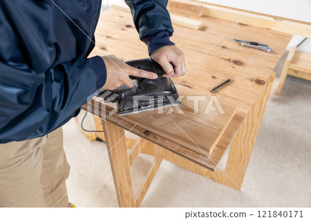 Sanding cedar wood 121840171