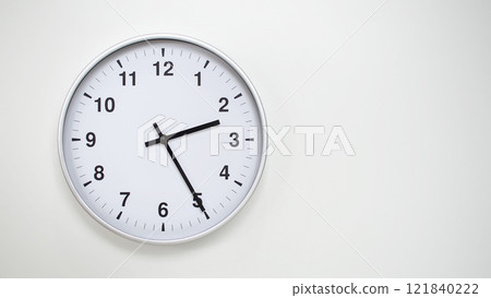 Minimalist White Clock with Silver Frame Striking 14.25/02.25 on White Background. Perfect for Time Management and Corporate Campaigns Minimalist White Clock with Silver Frame Striking 14.25/02.25 on White Background. Perfect for Time Management and Corporate Campaigns 121840222