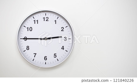 Minimalist White Clock with Silver Frame Striking 14.45/02.45 on White Background. Perfect for Time Management and Corporate Campaigns Minimalist White Clock with Silver Frame Striking 14.45/02.45 on White Background. Perfect for Time Management and Corporate Campaigns 121840226