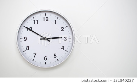 Minimalist White Clock with Silver Frame Striking 14.50/02.50 on White Background. Perfect for Time Management and Corporate Campaigns Minimalist White Clock with Silver Frame Striking 14.50/02.50 on White Background. Perfect for Time Management and Corporate Campaigns 121840227