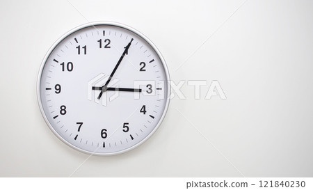 Minimalist White Clock with Silver Frame Striking 15.05/03.05 on White Background. Perfect for Time Management and Corporate Campaigns Minimalist White Clock with Silver Frame Striking 15.05/03.05 on White Background. Perfect for Time Management and Corporate Campaigns 121840230