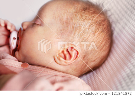 Close up of ear of newborn sleeping baby with pacifier Close up of ear of newborn sleeping baby with pacifier 121841872