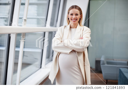 Happy smiling Beautiful confident pregnant blonde woman in stylish and fashionable clothing a white dress and blazer standing, looking at the camera in a corporate office setting Happy smiling Beautiful confident pregnant blonde woman in stylish and fashionable clothing a white dress and blazer standing, looking at the camera in a corporate office setting 121841893