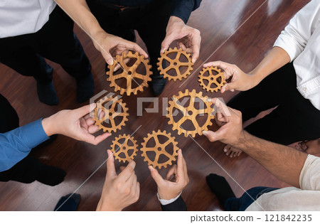 Business team joining cogwheel in circular together. Prudent Business team joining cogwheel in circular together. Prudent 121842235