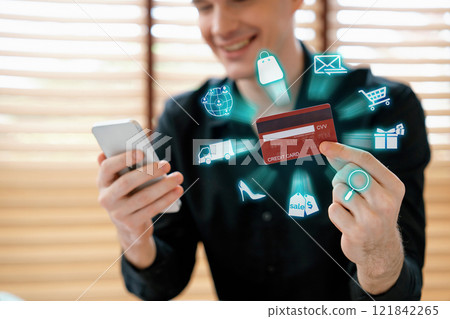 Consumer holding credit card using device shopping online inventory. Cybercash. Consumer holding credit card using device shopping online inventory. Cybercash. 121842265