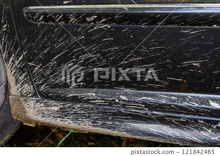 Car side covered in mud after off-road adventure through rough terrain in a rural area Car side covered in mud after off-road adventure through rough terrain in a rural area 121842465
